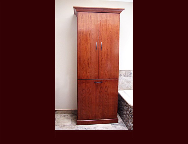 Cherry Bathroom Cabinet to match vanity. Double hamper lower drawer with linen storage above.