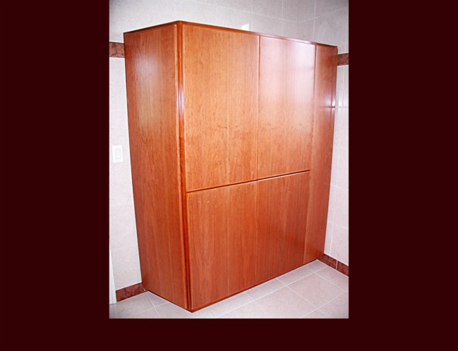 Cherry Master Bath Cabinet. Modern Flat Slab door style. Hamper and linen and wardrobe storage. Adjustable shelving.