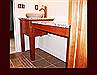 Maple vanity with flat skirting and posts. Attached dressing table with drawer.