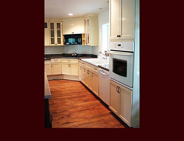 Painted Custom Maple Kitchen cabinets. Flat Panel door style with laminated countertops.